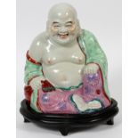 CHINESE PORCELAIN BUDDHA, TWO, H 9":  A seated  Buddha along with a fitted teak stand.