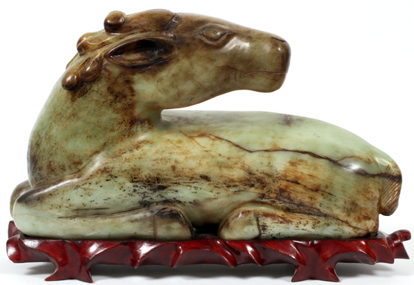 ARCHAIC JADE CARVED HORSE, H 10", L 17":  Green  to russet brown in color on a fitted wooden  stand.