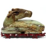 ARCHAIC JADE CARVED HORSE, H 10", L 17":  Green  to russet brown in color on a fitted wooden  stand.