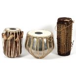 AFRICAN DRUMS, THREE, H 10"-15 1/2", DIA 7"-11":   Having animal fur, wood, and woven accents.   One