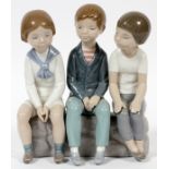 LLADRO PORCELAIN FIGURE GROUP, 'THREE BOYS  SITTING', H 7 1/2", #4980:  The Lladro "Three  Boys