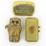 Three brass vestas - one in the form of an owl with glass eyes, one in the form of a purse and the