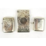 Two silver vesta cases and floral chased silver card case with Chester hallmark, the case 8cm long :