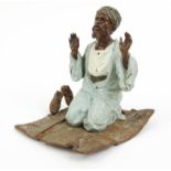 Cold painted bronze model of a Middle Eastern gentleman on a carpet, stamped Geschutzt and