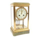 Brass four glass clock with floral painted dial and mercury pendulum, striking on a gong, with