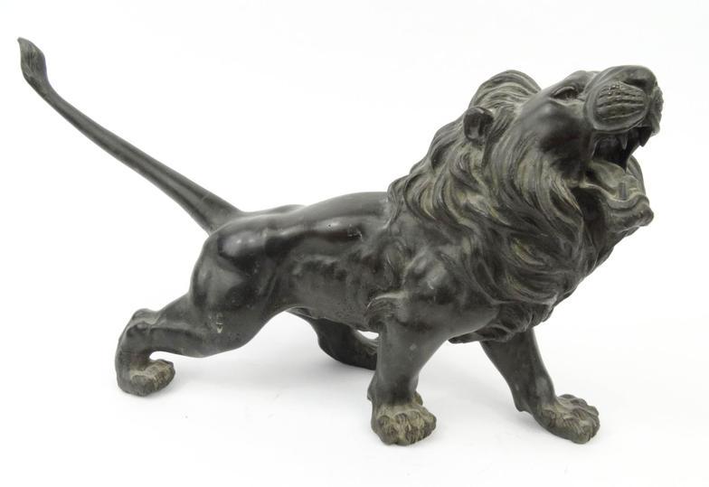 Large oriental bronze study of a lion, character marks to the belly, 52cm long : For Condition