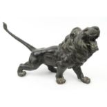 Large oriental bronze study of a lion, character marks to the belly, 52cm long : For Condition