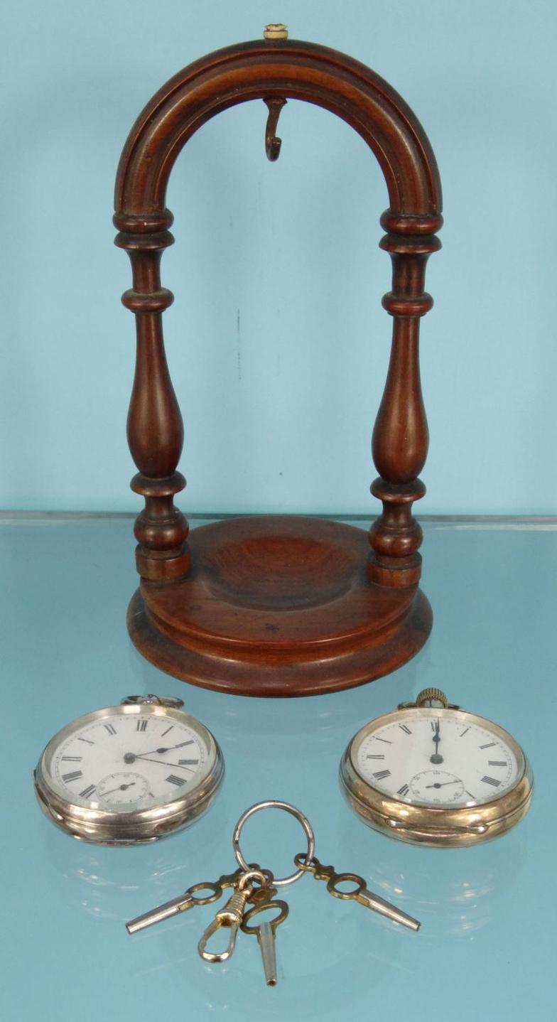 Two gentleman's silver open faced pocket watches and a mahogany watch stand : For Condition