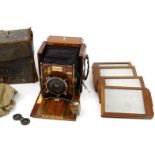 Folding mahogany Sanderson hand camera in a leather case, together with four extra plates, 15cm high