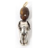 Novelty silver metal 'Thumb's Up' miniature nut headed doll with beaded glass eyes, registered