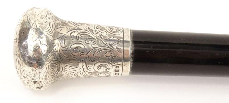 Ebonised wooden walking cane with silver handle and floral chased decoration, TWG London 1925-26,