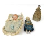Two Victorian bisque headed dolls - one with blue silk dress, one carrying a baby, the largest