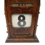 Oak cased desk calendar, 26cm high : For Condition Reports please visit www.eastbourneauction.com