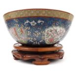 Large oriental porcelain fruit bowl with figures, birds, butterflies and flowers, raised on a