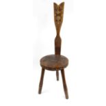 Ben Setter Arts and Crafts style carved wooden spinning chair, impressed 'Ben Setter & Totnes', 85cm