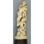 Large Indian paper knife carved with acrobats and chased silver mounted floral grip, 41cm long : For