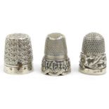 Three silver and white metal thimbles, the largest 2.2cm high : For Condition Reports please visit