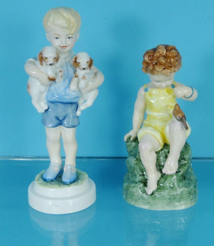 Two Royal Worcester china figures - Friday's Child Is Loving And Giving 3523 and a boy holding dogs,