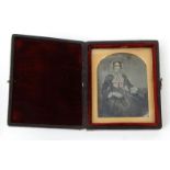 Two Victorian daguerreotype photographic pictures of a lady and gentleman, housed in velvet lined