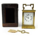 Brass carriage clock with enamelled dial, in a fitted case, 10cm high excluding handle : For