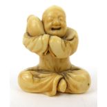 Oriental carved ivory Netsuke of a boy and a baby, 3.5cm long : For Condition Reports please visit