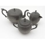 Chinese pewter three piece tea service, the teapot with liner, each item with chased decoration