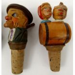 Carved hand painted novelty wooden bottle stopper, together with three mechanical wooden bottle