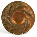 Newlyn style Arts and Crafts circular copper dish embossed with a continuous band of fish, 31cm