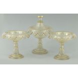 Set of three Victorian floral glass tazzas all with gilt edges, one with a lid, largest 26cms tall :