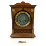 Arts and Crafts walnut mantel clock with painted Eidelweiss dial and French movement chiming on a