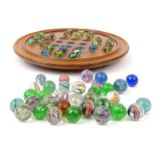 Mahogany solitaire board and assorted colourful glass marbles, 24cm diameter : For Condition Reports