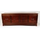 Oriental hardwood sideboard fitted with four cupboard doors, 183cm long x 66cm high x 48cm deep :