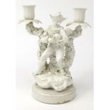 Continental white porcelain candelabra modelled as a jester with a dog, 23cm high : For Condition