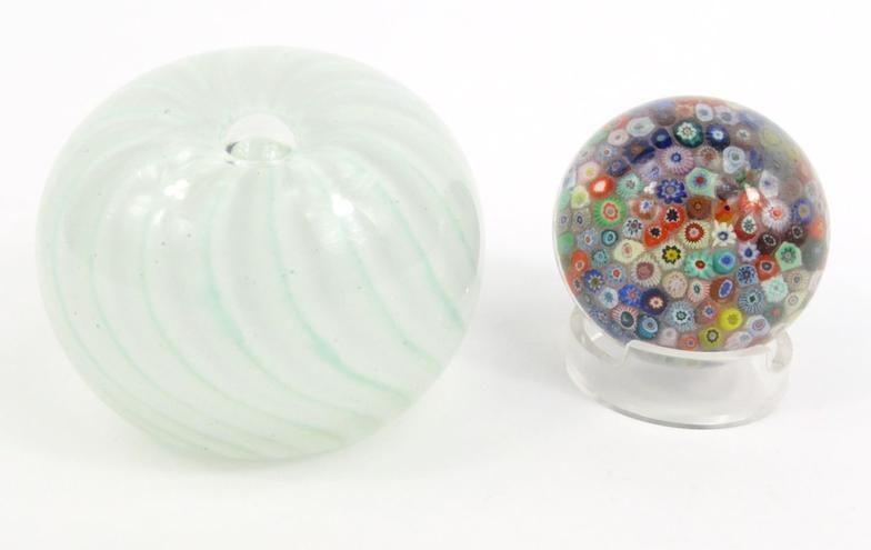 Two globular glass paperweights - the larger signed foundry No 186', the other with colourful