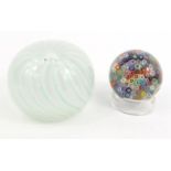 Two globular glass paperweights - the larger signed foundry No 186', the other with colourful
