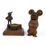 Black Forest carved dog brush holder, together with a gnome match stand, the largest 16cm high : For