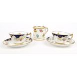 Two miniature Royal Crown Derby porcelain cups and saucers hand painted with flowers, together