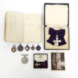 Military interest boxed silver MBE including a dress version, together with paperwork, 1940s