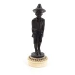 Small bronze figure of a boy on a circular ivory base, 9cm high : For Condition reports please visit