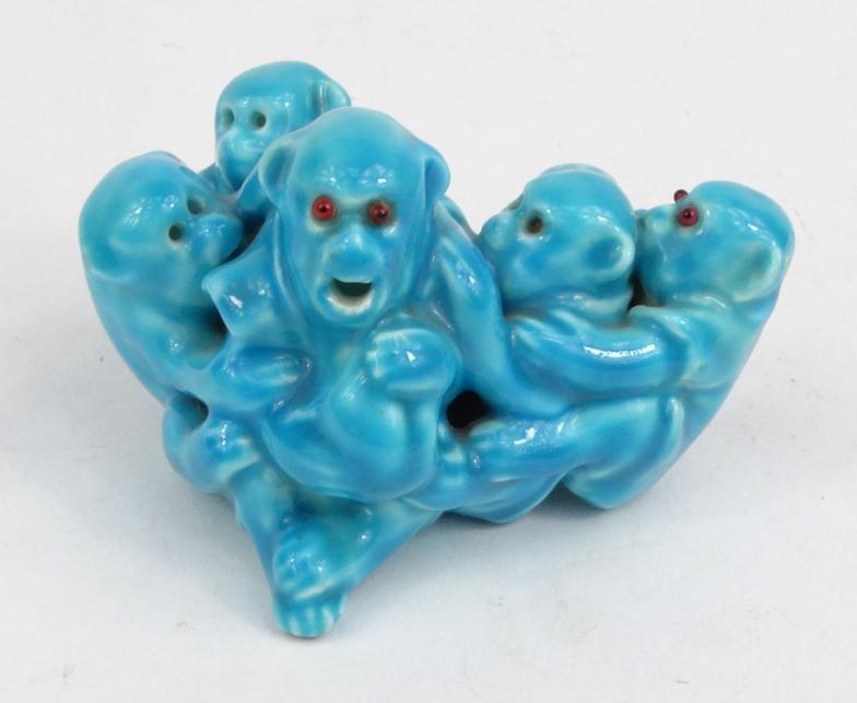 Good quality porcelain model of a group of monkeys in a turquoise glaze with red beaded glass