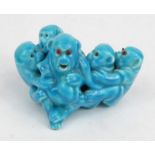 Good quality porcelain model of a group of monkeys in a turquoise glaze with red beaded glass