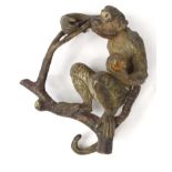 Cold painted bronze model of a monkey up a tree, stamped 'Geschutzt', 8cm high : For Condition