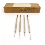 Four metal scalpels housed in a wooden box - three stamped Weiss London, each 12cm long : For