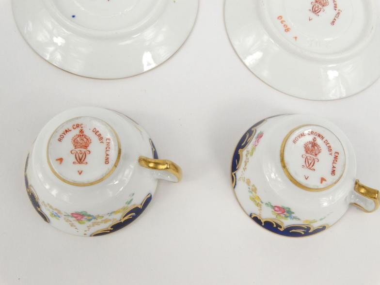 Two miniature Royal Crown Derby porcelain cups and saucers hand painted with flowers, together - Image 7 of 8
