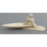 Inuit carved walrus ivory model of an Eskimo in a canoe, H? 19.P 50K.IV43 incised to base, 20cm long