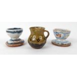 Two Mark Hewitt Wenfordbridge Studio pottery eggcups hand painted with circles, together with a