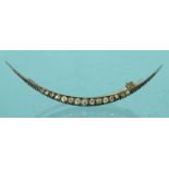Unmarked gold and diamond crescent shaped brooch, 5.5cm long, approximate weight 2.5g : For