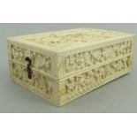 Oriental Chinese ivory card box finely carved with panels of flowers and elders, 13cm long : For