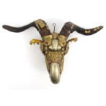 Middle Eastern brass and copper ram's head wall plaque set with beaded glass eyes, 24cm high : For