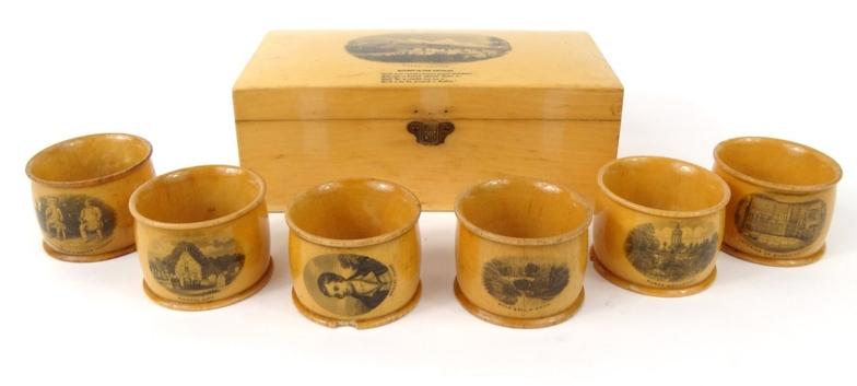 Boxed set of six wooden Mauchlin ware napkin rings decorated with Robbie Burns, the lid decorated